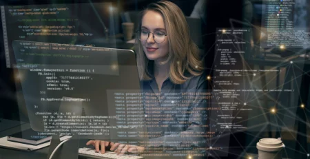 Woman in front of a computer showing programming code referring to Best Programming Languages to Learn in 2024 for Career Growth.