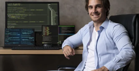 A person in front of a computer and on the screen you can see programming codes demonstrating the Software Developer Skills​