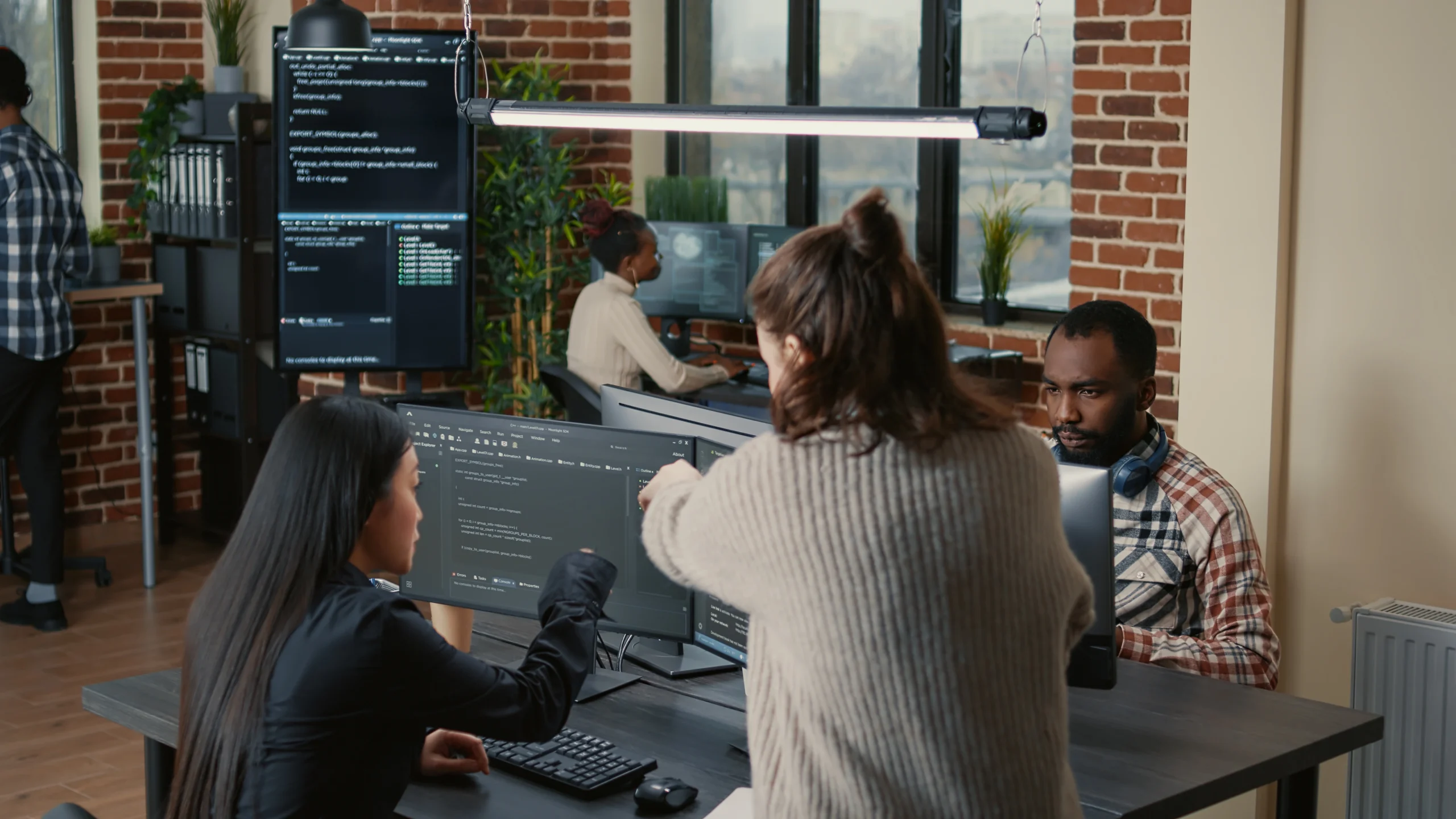 group of people working in an office referencing embrace Custom Software Solutions