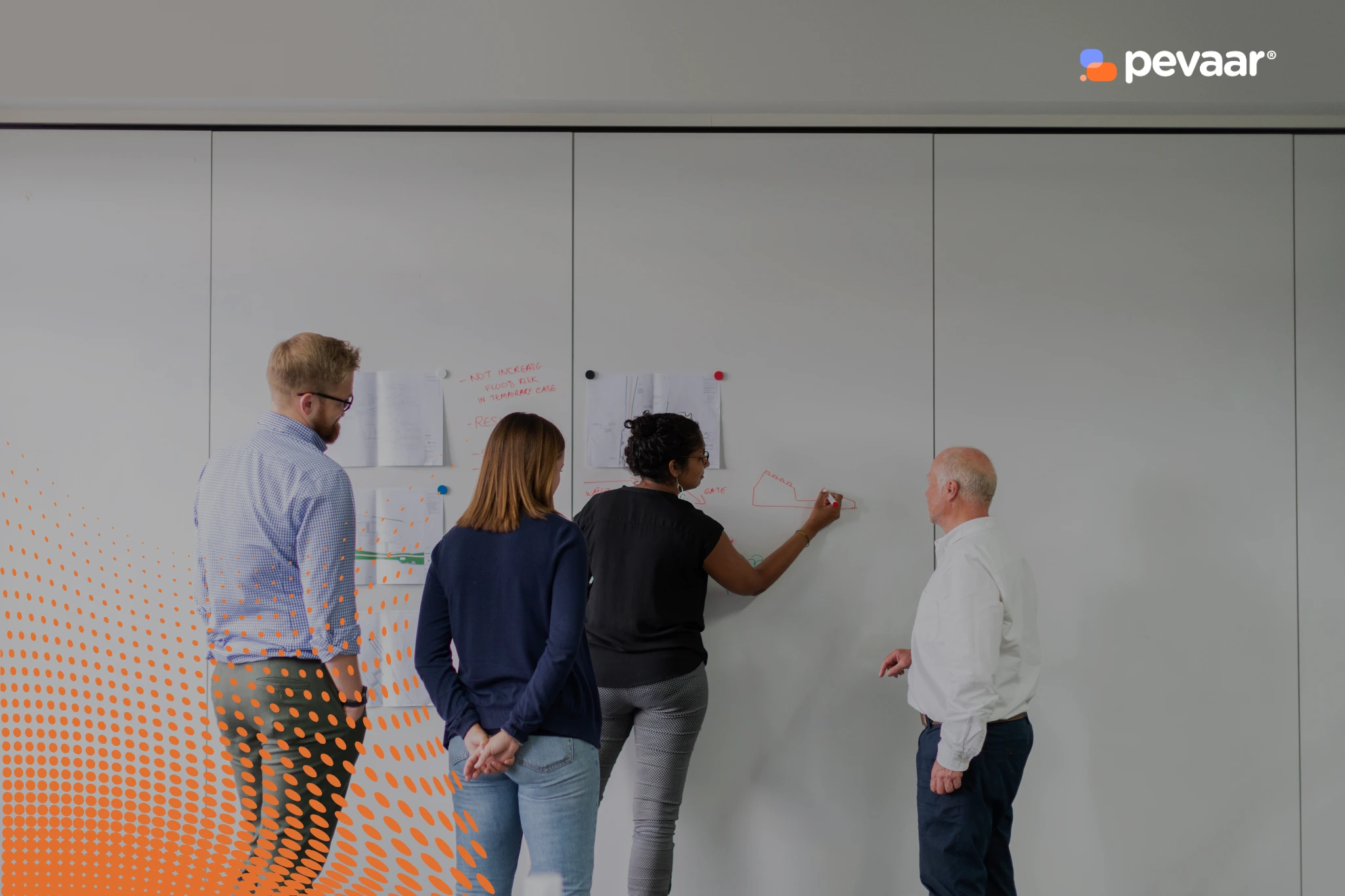 Team collaborating on a whiteboard to design a Power Automate workflow, discussing data structures and how to flatten an array for easier processing.