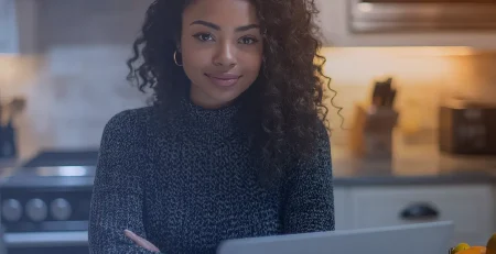 woman in front of her laptop at home looking at 'What is Microsoft Power Apps used for?'