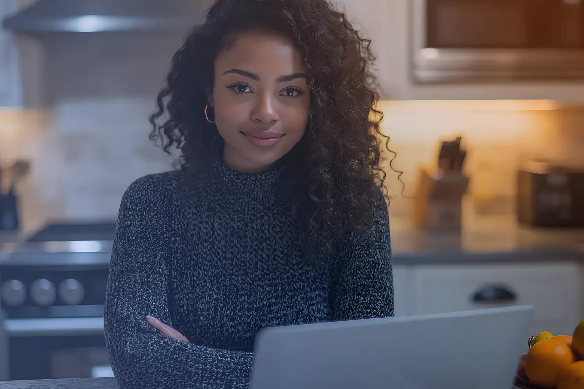 woman in front of her laptop at home looking at 'What is Microsoft Power Apps used for?'